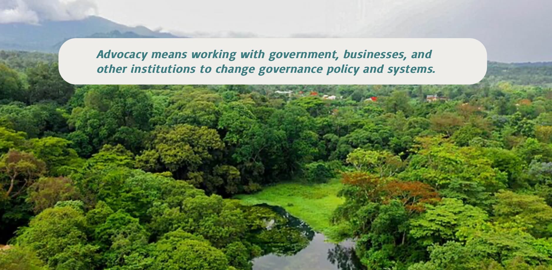 Background photo of a mountain range and forest. A quote overlay near the top says, "Advocacy means working with government, businesses, and other institutions to change governance policy and systems."