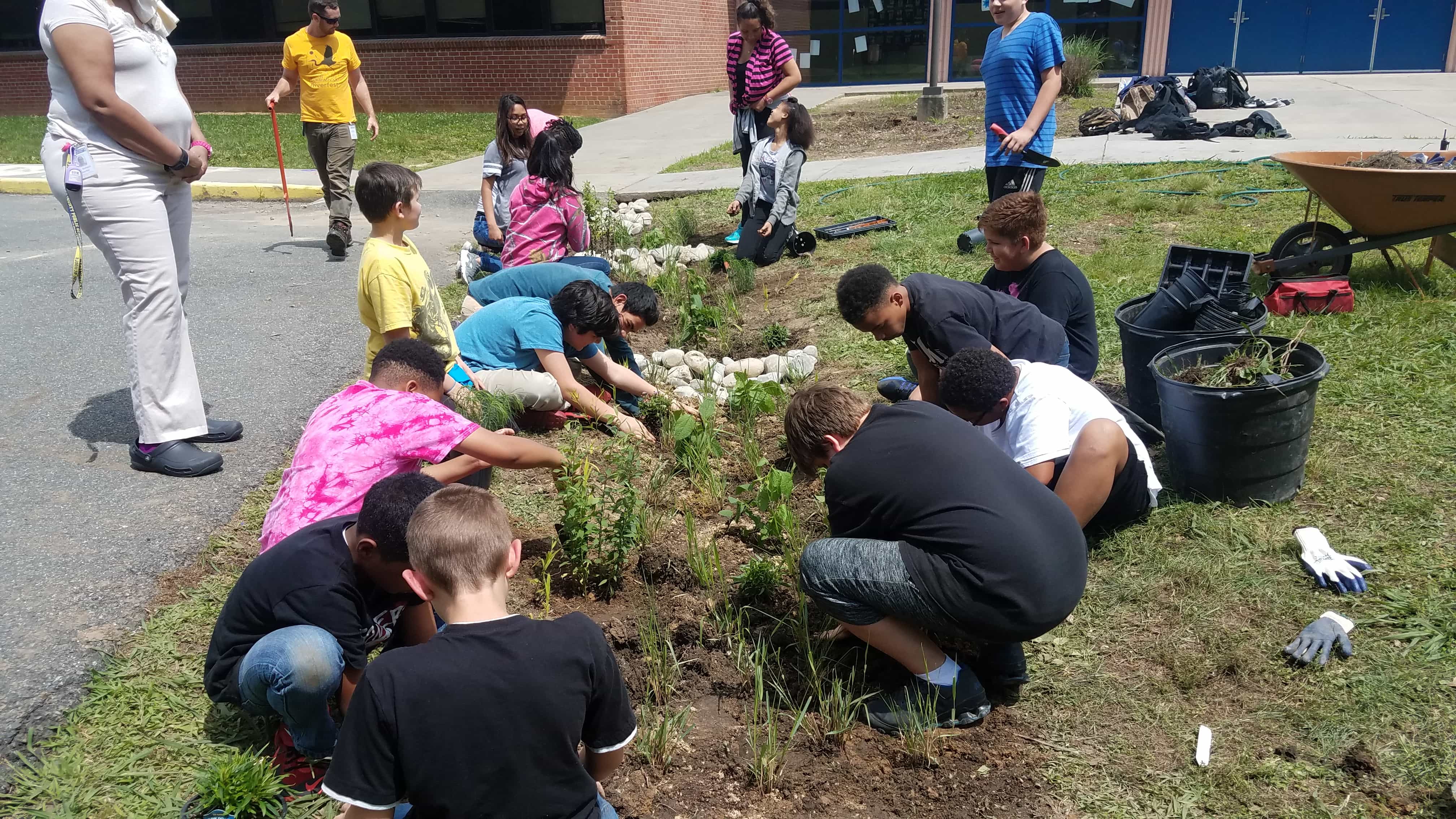 Students build a bioswale on school grounds with the support from the facilities department