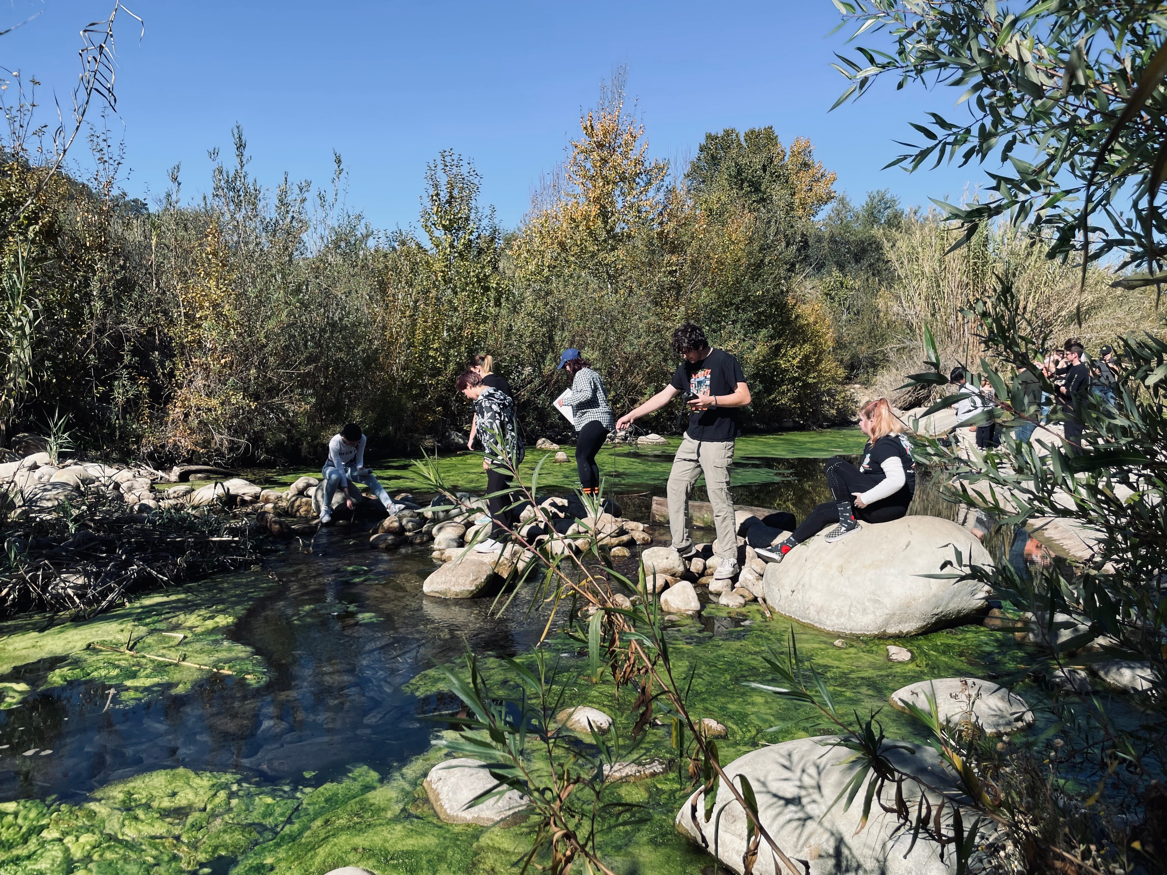 students water testing in stream