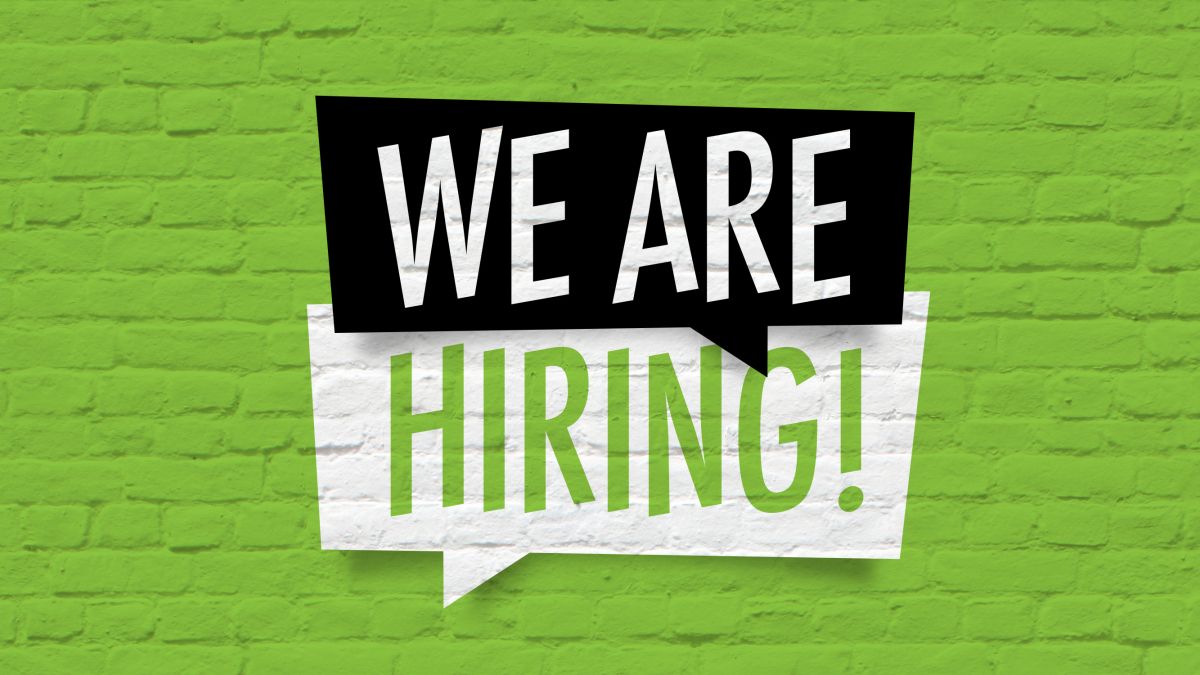 Call boxes saying, "We Are Hiring!" against a green brick background