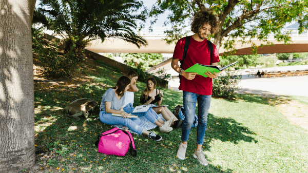 Young people reading and spending time together in the park