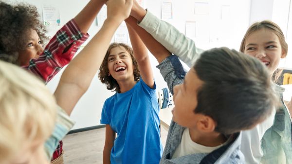 Group of junior high school students giving a group high five