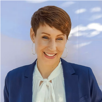 Photo of a smiling person against a light shady background