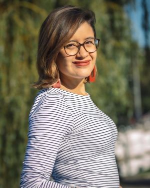 Fátima Delgado Medina outdoors in a striped shirt. 