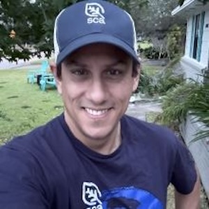 Jaime González smiles while standing outdoors