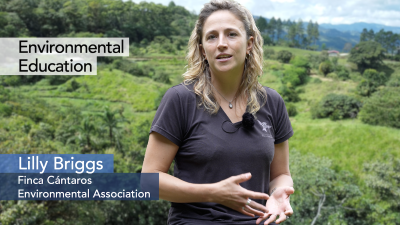 Image of Lilly Briggs speaking with tropical forest in the background