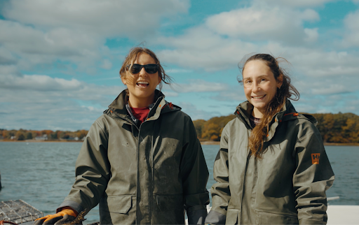 Two women aboard a boat and out on the water