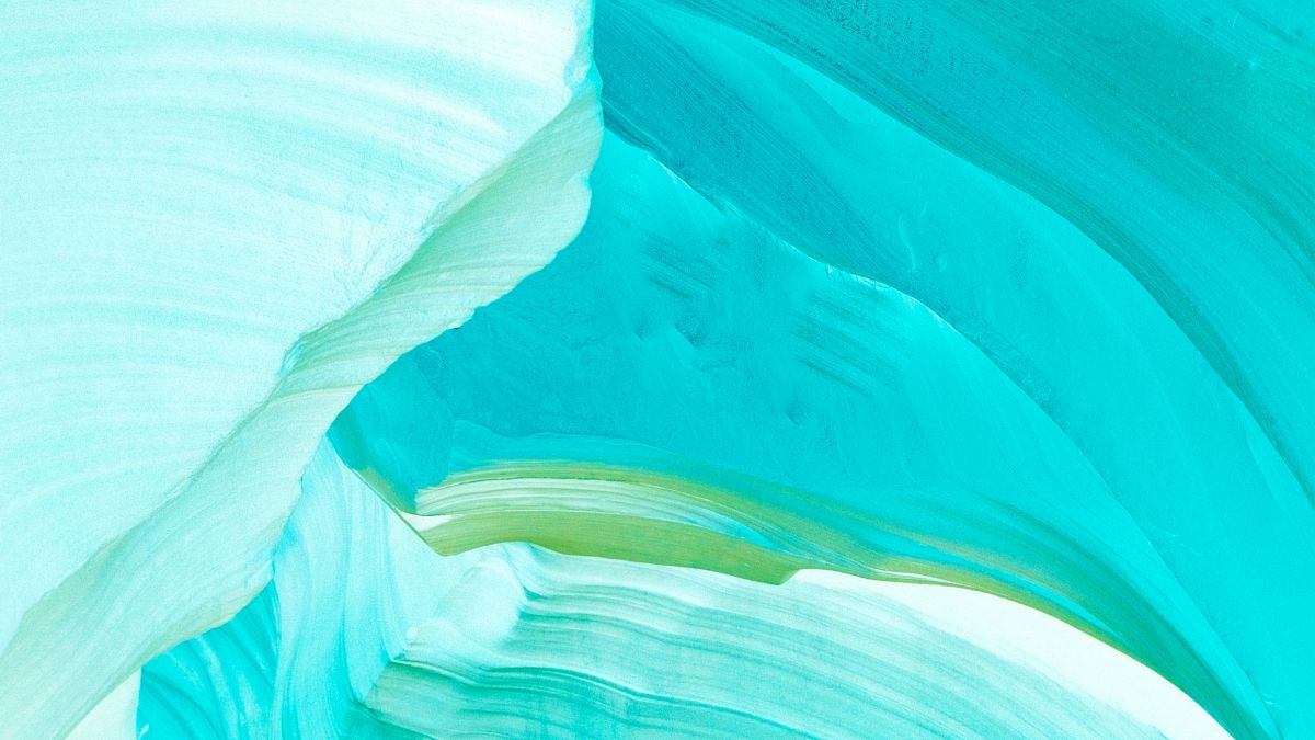 Photograph of massive blue and green snow layers from a glacier, tightly condensed