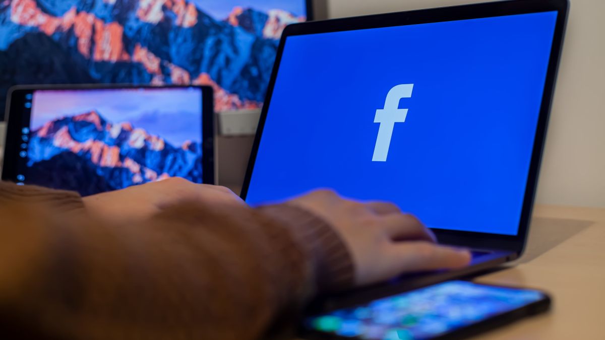 Photo of a laptop screen with the "f" facebook logo shown on screen