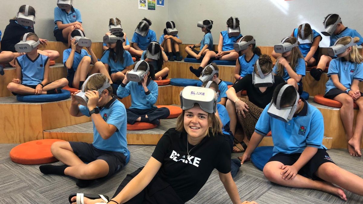 Children in a classroom use VR headsets to learn about the ocean. 