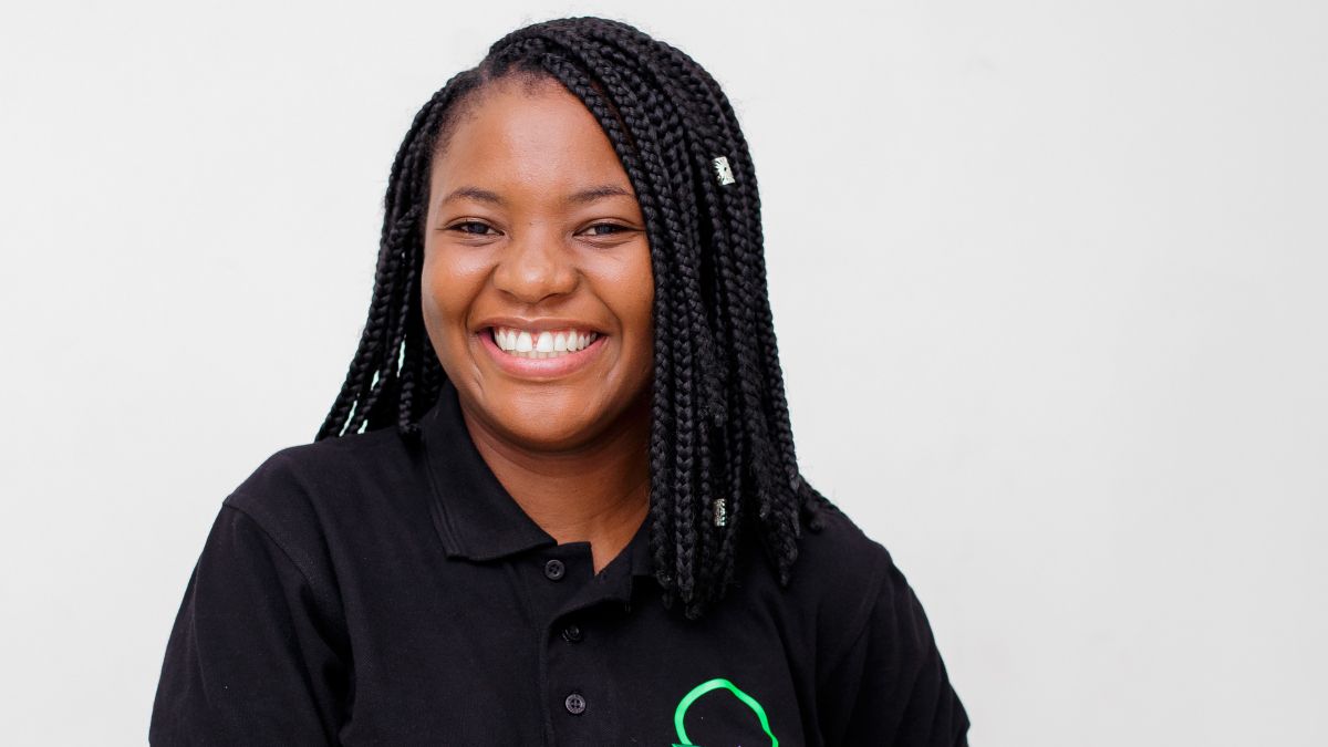 A smiling Joy Hayley Munthali in a black polo shirt