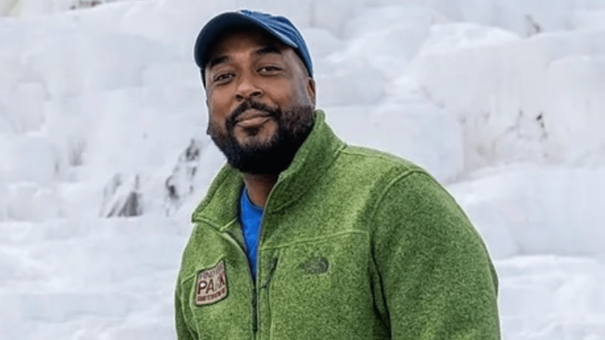 Stefan Moss stands in front of a snow-covered mountain