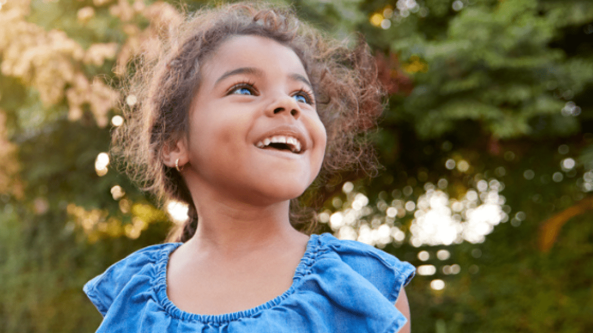 Background is a photo of a smiling girl outside. In the top left corner is a green overlay with text, “NatStart 25.”