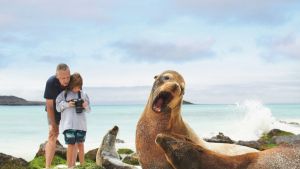 Adult and child photographing sea lions in the Galápagos, photo by Stewart Cohen