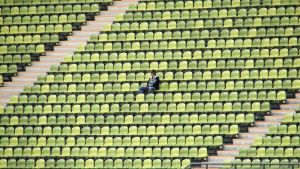 One spectator sitting in an empty stadium