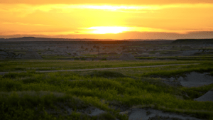 The sun sets on the dark green plains of South Dakota