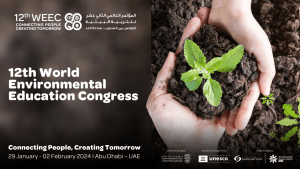 Brown background with white text on the left and a photo of a pair of hands holding some soil and a seedling. The white text says, "12th World Environmental Education Congress."