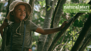 young black girl in tree