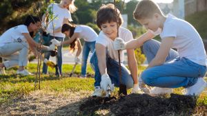 young students planting trees