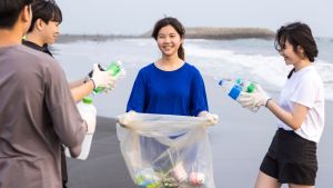 Group of students collect plastic waste on a beach