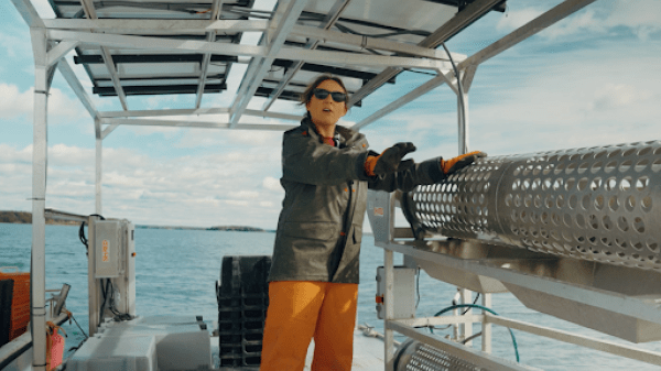 Alicia shows off the tumbler on their work barge
