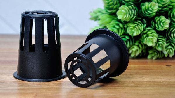 Black net pots for hydroponics growing media on wooden floor