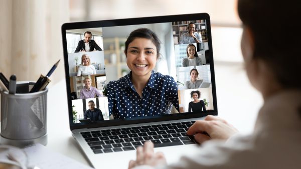 Person watching webinar with multiple people on laptop