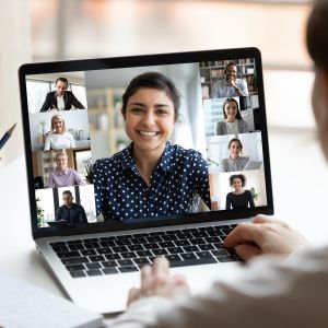 Person watching webinar with multiple people on laptop