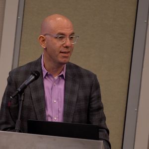 Dr. Levy standing at a podium