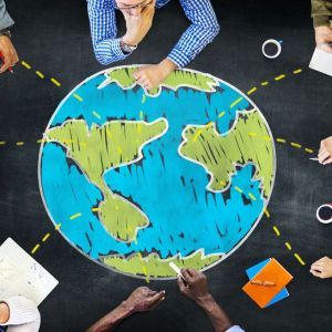 Eight diverse adults sitting around a chalk drawing of earth.