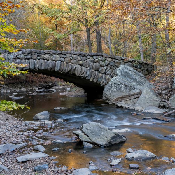 An autumn view of the Boulder Bridge in Rock Creek Park, Washington, DC.