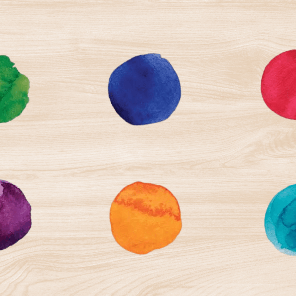 Six single paintdrops, ranging from green to blue, on a wooden background