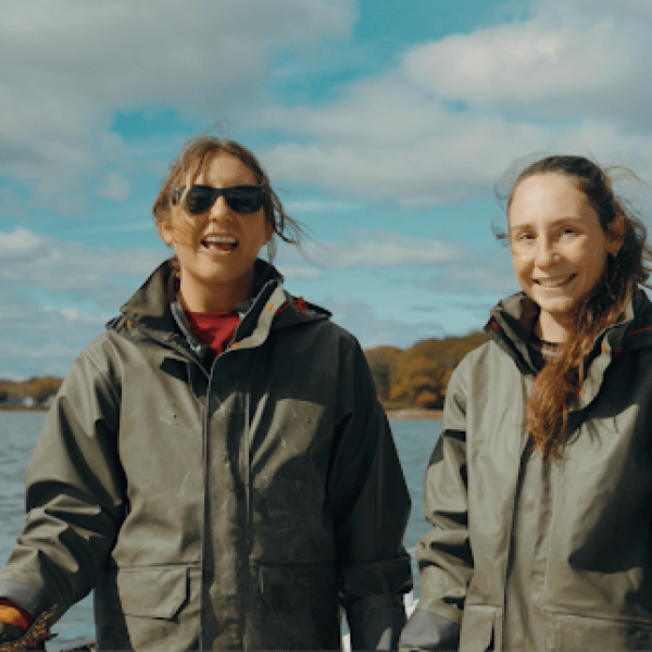 Two women aboard their boat and out on the water